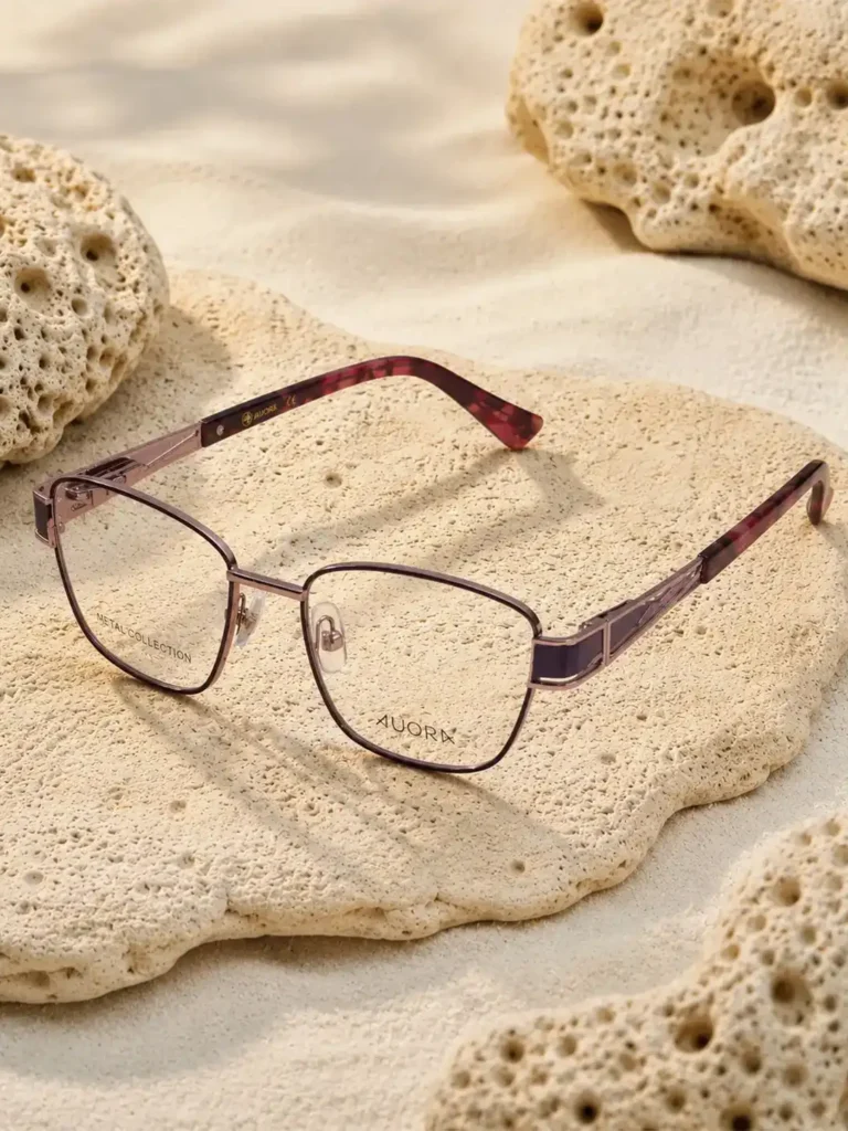 Auora Eyewear premium metal optical frame on a textured stone surface