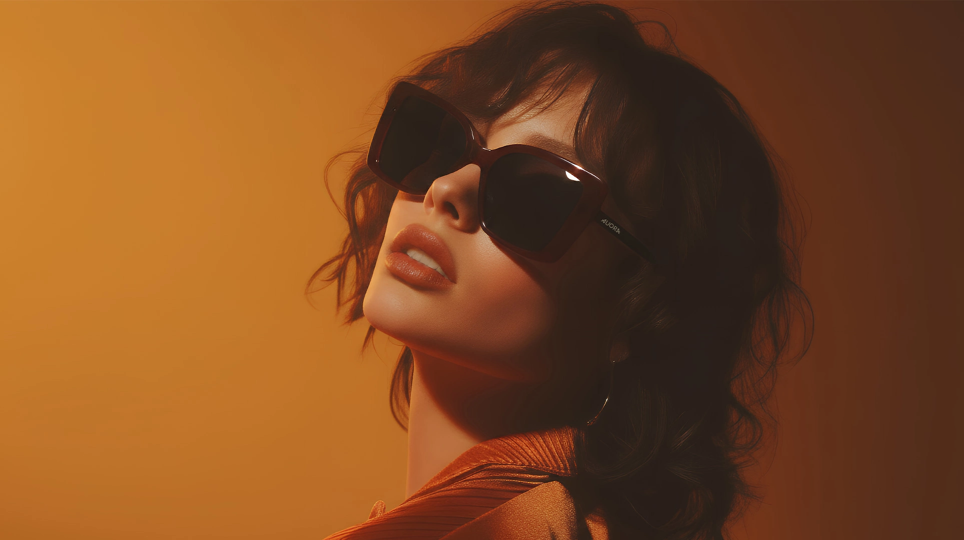 Auora Eyewear burgundy oversized sunglasses worn by a fashion model in warm studio lighting.
